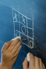 Russia. Saint Petersburg. Children are playing tic-tac-toe on a board.