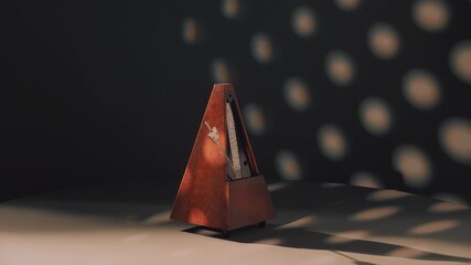 artistic representation featuring classic wooden metronome in moody studio lighting conditions