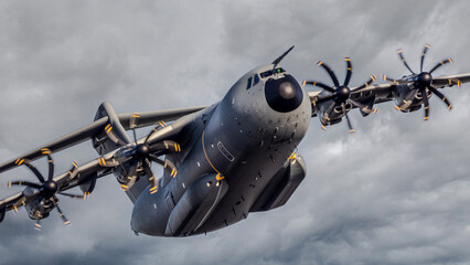 Modern military airlifted against a grey sky. Air force cargo plane.