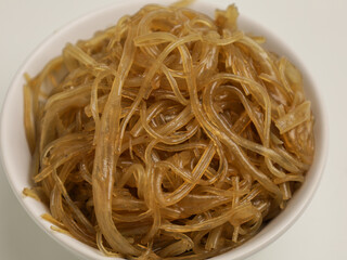 Stir fried glass noodles in white bowl