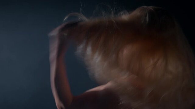 blonde woman playfully adjusts her hair while striking a confident pose. The atmosphere suggests a lively and exciting nighttime setting.