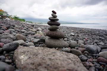 Fotobehang Zen Stenen Stone pebble balancing in the beach. Sea rocks formation for stability and life balance concept. Peace and harmony symbol. Stack of rock or stones. Be balance concepts.  © Maria Marganingsih