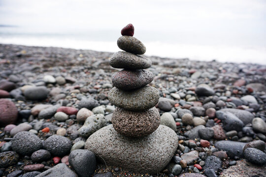 Stone pebble balancing in the beach. Sea rocks formation for stability and life balance concept. Peace and harmony symbol. Stack of rock or stones. Be balance concepts.