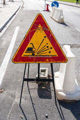 road sign for a bumpy road, placed on the carriageway