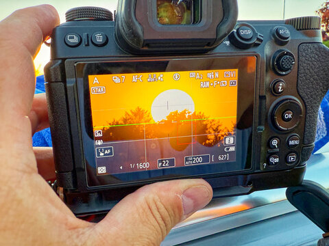 Handheld camera framing a sunset dropping to the horizon - Powered by Adobe