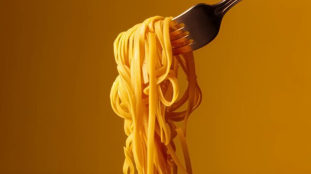 A fork holding a bundle of spaghetti against a bright yellow background.