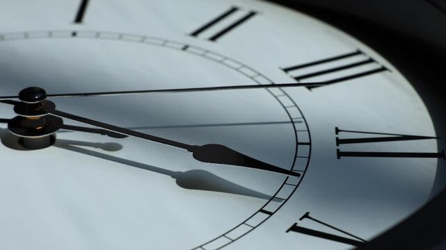 Sun and sky reflecting in the watch during the time passing by. Time lapse on a modern white Clock on white.  Close up to a wall clock, with running time pointer. Wall clock show the running time. 