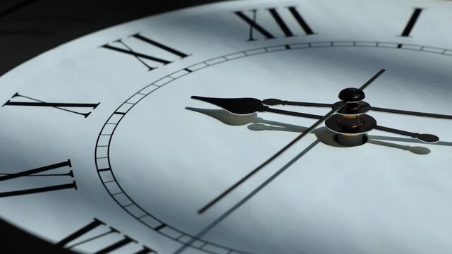 Sun and sky reflecting in the watch during the time passing by. Time lapse on a modern white Clock on white.  Close up to a wall clock, with running time pointer. Wall clock show the running time. 