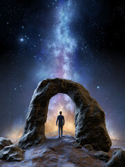 Man standing under a rocky arch formation