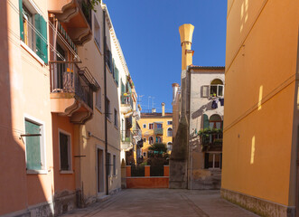 Traditional courtyard with colorful residential buildings and balconies in Venice, Italy