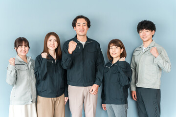 Fototapeta premium Employees and staff (businessmen and businesswomen) wearing work clothes working at small and medium-sized enterprises such as factories and construction companies 
