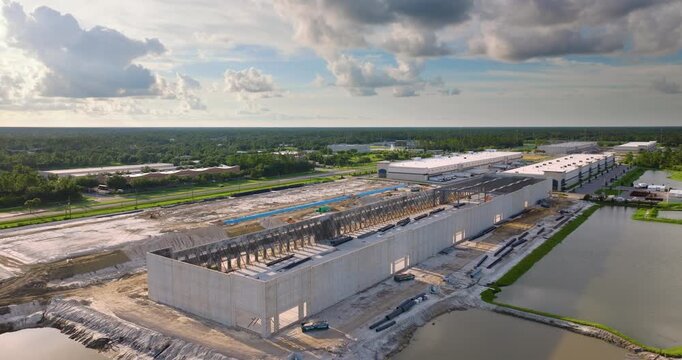 Development of commercial real estate in USA. Construction works on monolithic frame at large building site of logistics distribution warehouse.