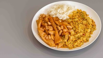 A classic Brazilian dish known as dobradinha, prepared with beef tripe, white beans, and tropical spices, served with traditional farofa made with toasted cassava flour.