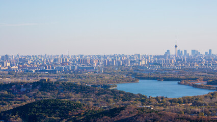 Naklejka premium Aerial panorama of Beijing city skyline and natural landscape at sunset, China