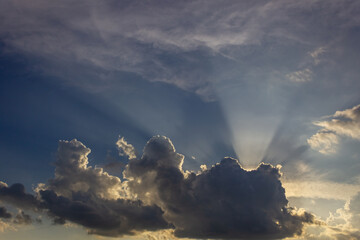 Sunset sky with clouds and sun rays. Beautiful natural background.