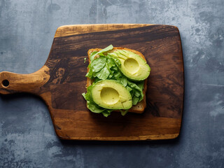 Avocado toast with neatly fanned slices on toasted bread placed on wooden table, top view in soft studio light, simple food styling for cafe menus.