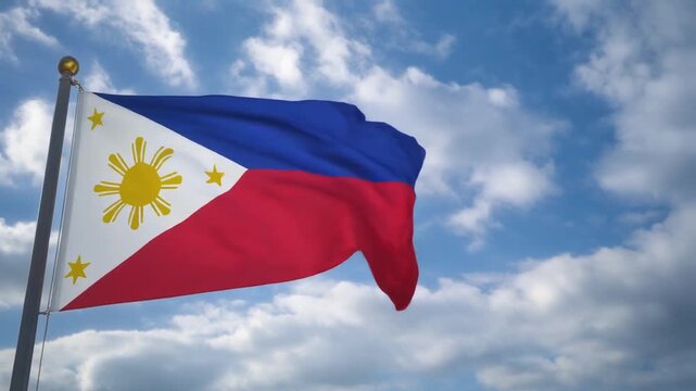 The flag of the Philippines waving in the blue sky with clouds
