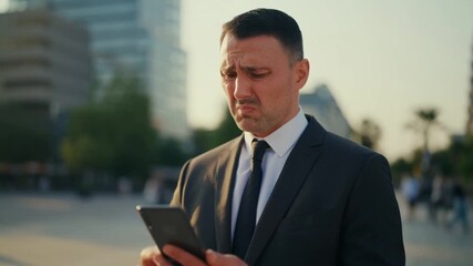 Anxious man in a business suit reacts while using a tablet Stock Video - Powered by Adobe