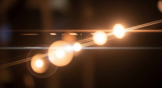 Close-up view of glowing string lights with bokeh effect against a dark background with warm tones.