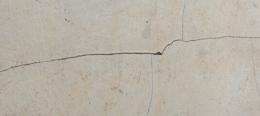 Weathered concrete wall with fine cracks