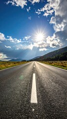 Road stretches into sunny landscape