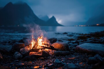 Fototapeta premium Campfire on a dark beach at twilight