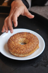 Hand reaching for a delicious donut on a table