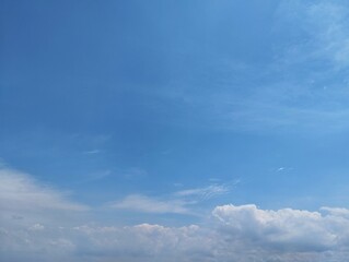 Clear blue sky with clouds in summer season. Copy space 