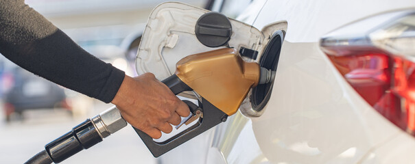 Man Refill and filling Oil Gas Fuel at station. Gas station - refueling.
