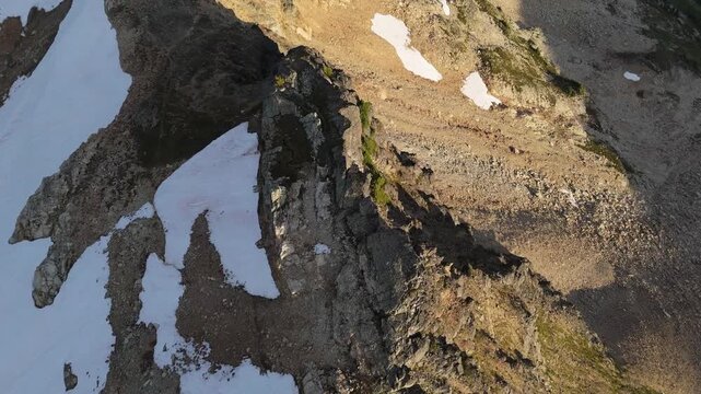Aerial View of a Rugged Mountain Ridge with Snow Patches in British Columbia, Canada