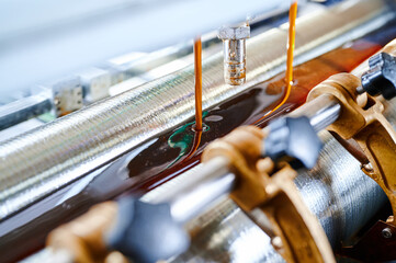 Precision glue application in a manufacturing facility, showcasing advanced glue-spreading technology at work