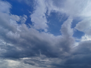 Fototapeta premium Blue sky with billowing white clouds and atmospheric cloudscape