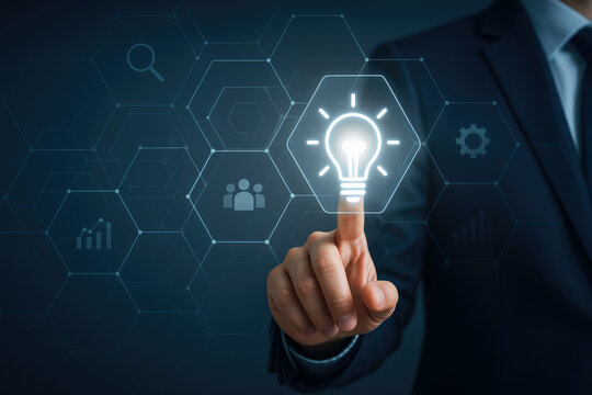 Businessman touching a digital lightbulb icon representing innovation and ideas in a network hand finger - Powered by Adobe