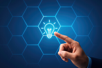 Finger touching glowing lightbulb icon within a hexagonal grid on a blue digital background pointing