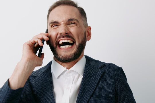 Businessman on a call, professional and confident, laughing with bright energy against a solid colored background, conveying positive mood and strong communication. - Powered by Adobe