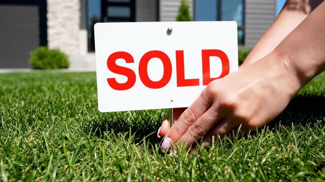 Real Estate Sold Sign on Lawn