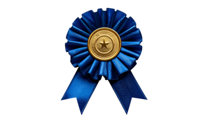 Close-up of a blue ribbon with gold center and star emblem on a black background