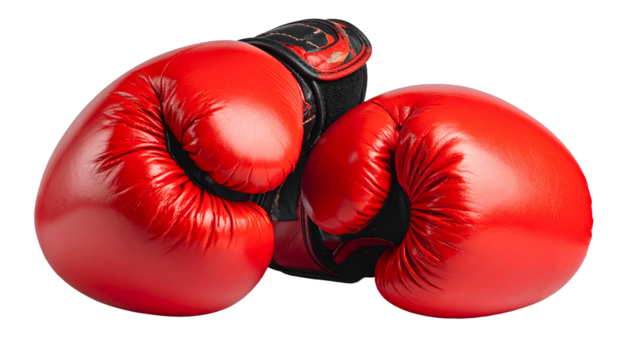 A pair of vibrant red boxing gloves, one resting on the other, isolated against black