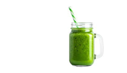 Green smoothie in a clear mason jar with striped straw, isolated on black background
