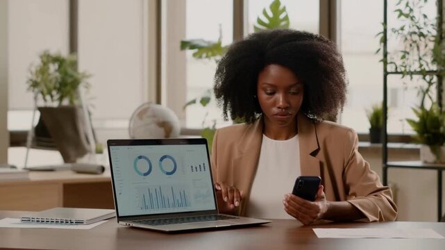 A focused woman multi-tasking on her work in her modern office Stock Video