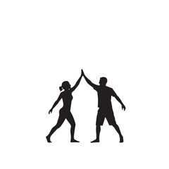 Silhouette of two friends high-fiving, against a sunset beach.