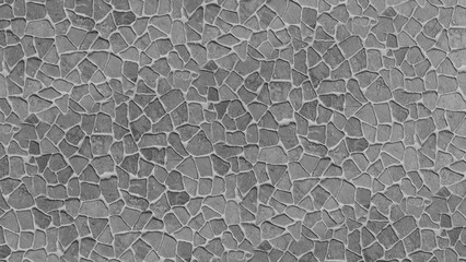 Abstract background pattern of an uneven grey stone mosaic wall, showcasing natural texture and irregular rock fragments creating a rustic and earthy surface design