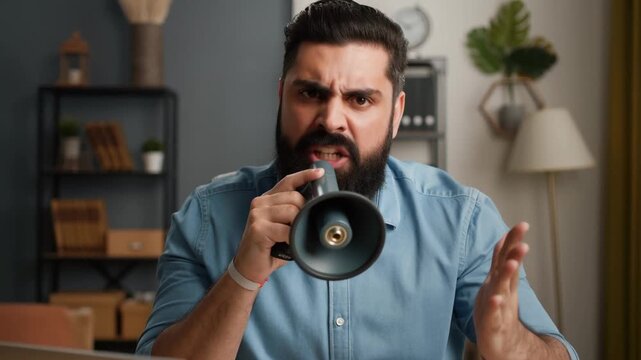 A man passionately using a megaphone, making an announcement or expressing his views with a serious expression Stock Video