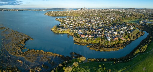 Aerial view of Westmere, Auckland, New Zealand, showcasing the city skyline, residential areas, and waterways. The photo highlights the urban landscape and natural beauty of Auckland.