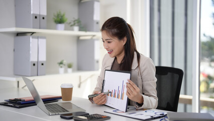 Asian business woman presenting data charts online video call modern office corporate meeting strategy digital growth