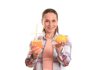 A middle-aged woman in a plaid shirt and pink T-shirt shows emotion while holding an orange. Shot on a white background, close-up.