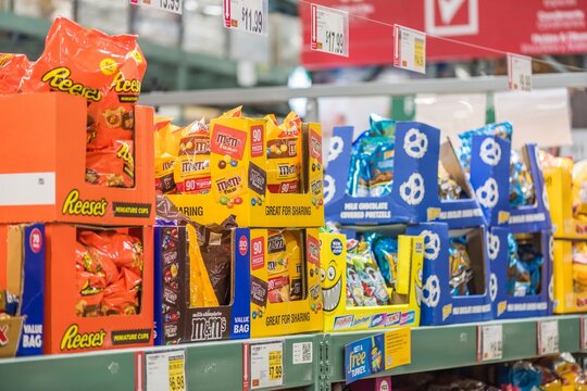 Candy aisle filled with colorful treats in a supermarket in Orlando, Florida, showcasing various brands and packaging