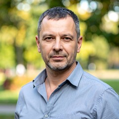 Fototapeta premium Portrait of a confident middle-aged man in a park setting.