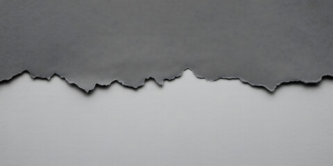 Torn dark gray paper edge against a lighter gray background