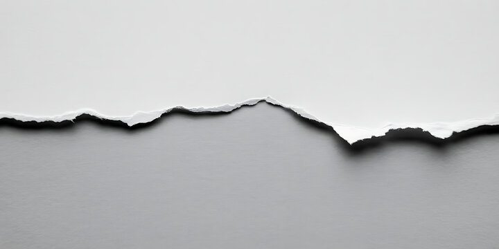 Torn white paper edge against a gray background, symbolizing separation or a break